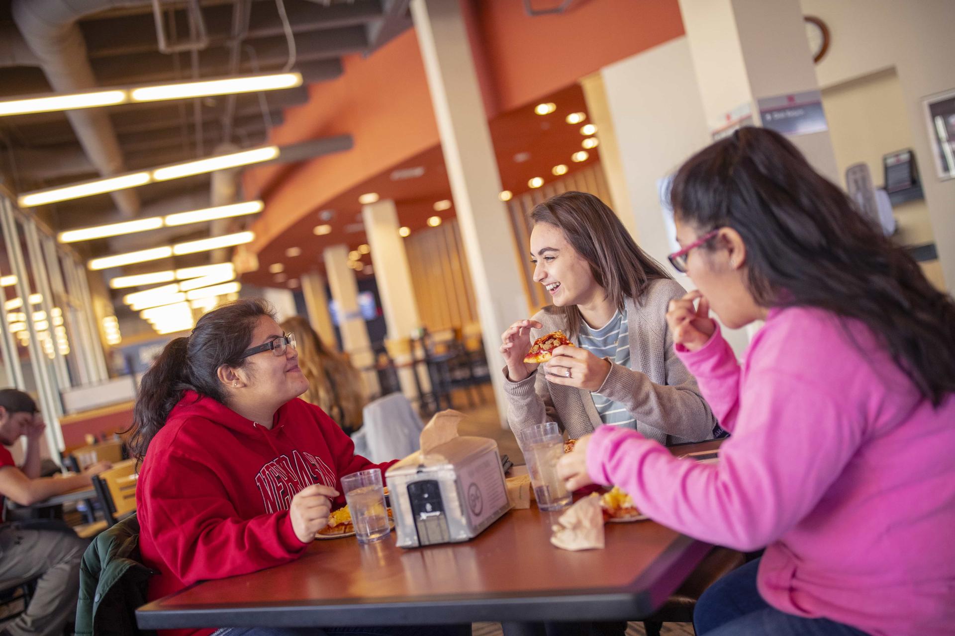 Female students dine together in the Harper Dining Center