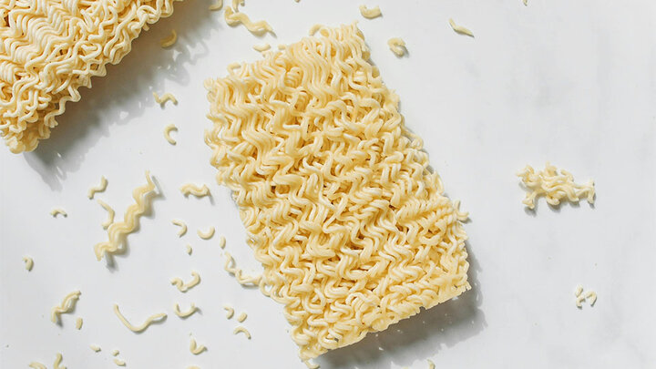 Uncooked ramen noodles on white background.