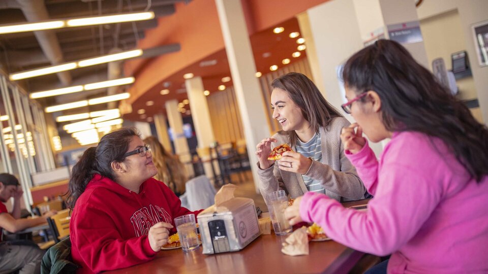 Female students dine together in the Harper Dining Center
