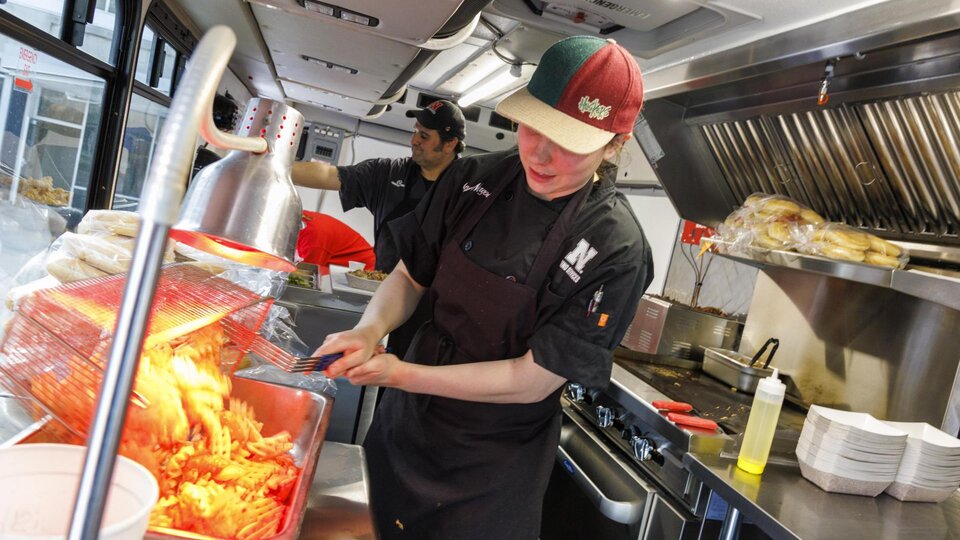 Harper Smokehouse Food Truck staff prepare dishes to be served