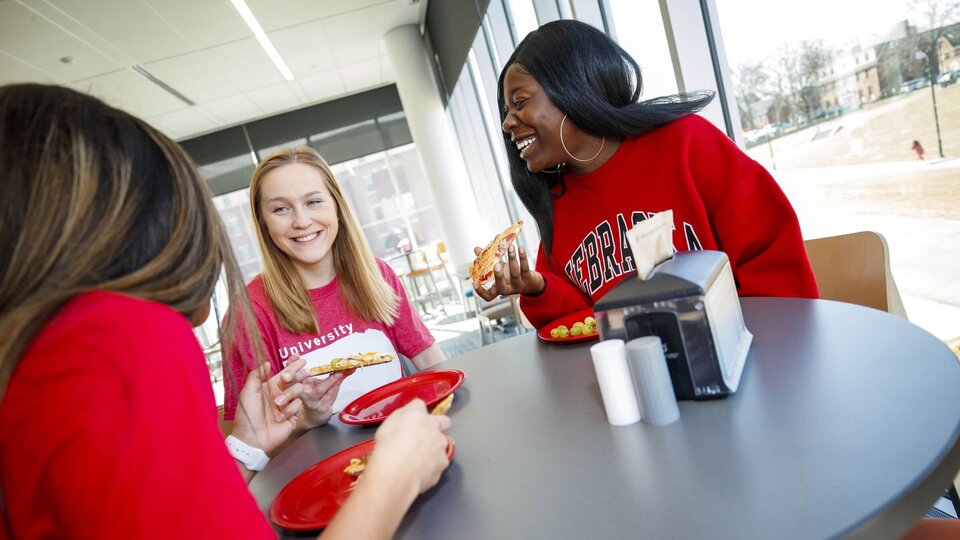 Three students dining in Willa Cather Dining Center.